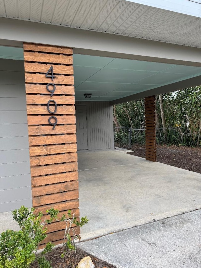 exterior space with fence and a carport