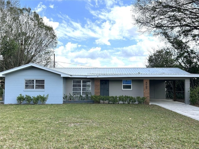 single story home with an attached carport, metal roof, and a front lawn