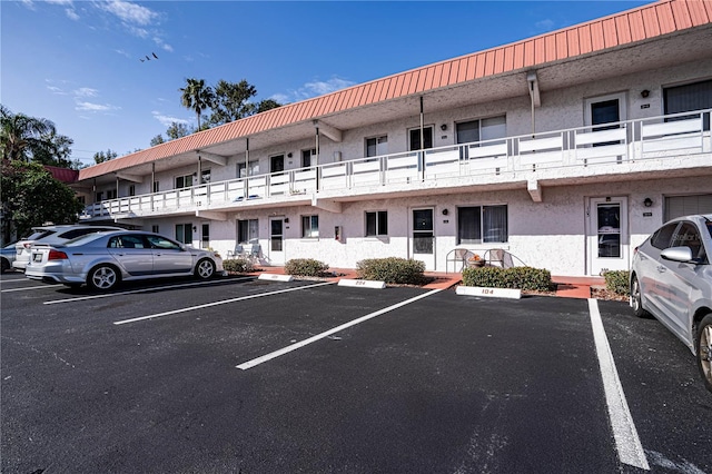 view of building exterior featuring uncovered parking