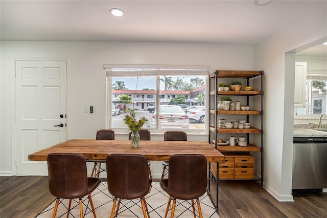 dining space with dark wood finished floors and baseboards