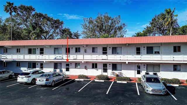 view of building exterior with uncovered parking