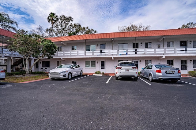 view of building exterior featuring uncovered parking