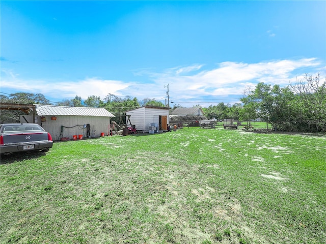 view of yard with an outdoor structure and fence