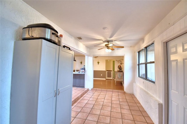 unfurnished room featuring visible vents, ceiling fan, and light tile patterned flooring