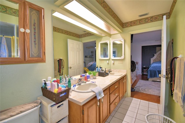 ensuite bathroom with double vanity, visible vents, a sink, and ensuite bathroom