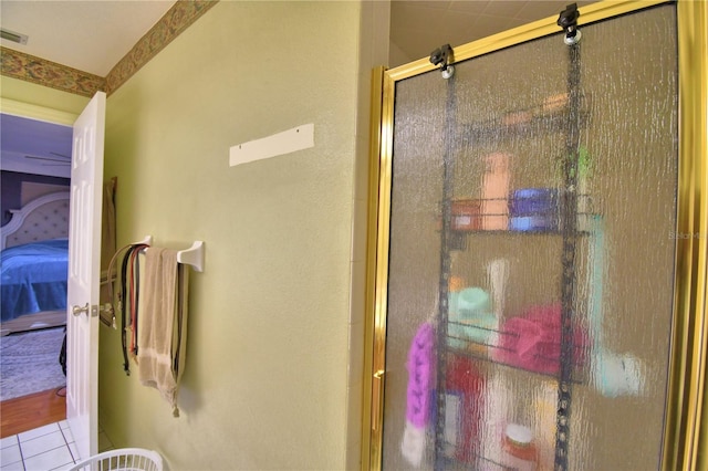 full bath with a shower with door, ensuite bath, visible vents, and tile patterned floors