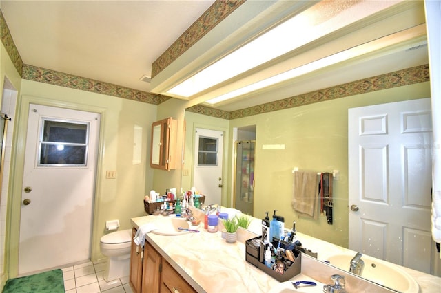 full bath featuring curtained shower, vanity, toilet, and tile patterned floors