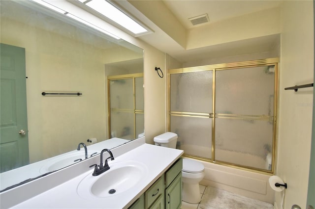 bathroom featuring tile patterned flooring, toilet, vanity, visible vents, and combined bath / shower with glass door