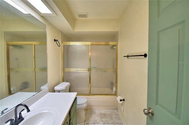 full bathroom featuring shower / bath combination with glass door, visible vents, toilet, vanity, and tile patterned floors