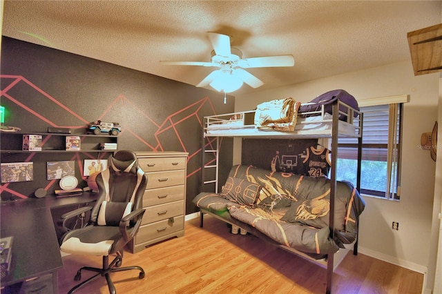 office space featuring a textured ceiling, baseboards, and wood finished floors