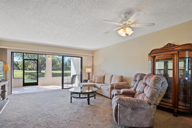 carpeted living area with ceiling fan and a textured ceiling