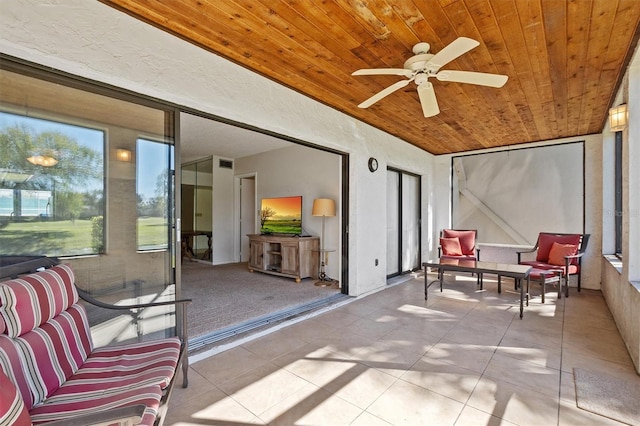 sunroom / solarium featuring ceiling fan and wood ceiling