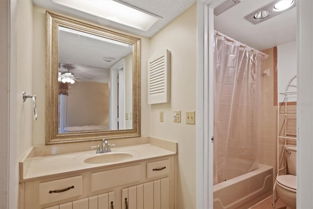 bathroom with a ceiling fan, shower / bath combo, vanity, and toilet