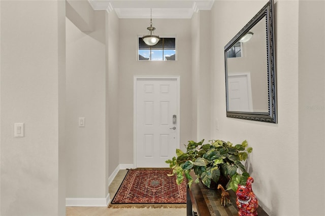 entrance foyer with ornamental molding and baseboards