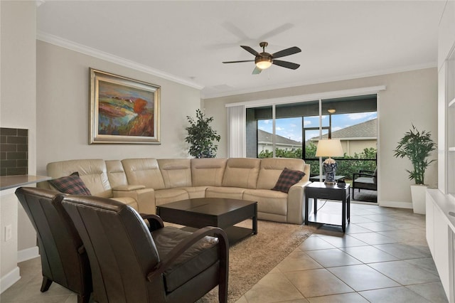 living room with ornamental molding, a ceiling fan, baseboards, and light tile patterned floors