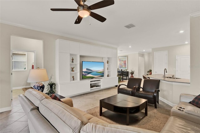 living area with ornamental molding, visible vents, baseboards, and light tile patterned flooring