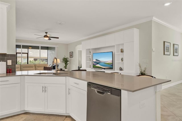 kitchen with a peninsula, a sink, white cabinetry, open floor plan, and dishwasher