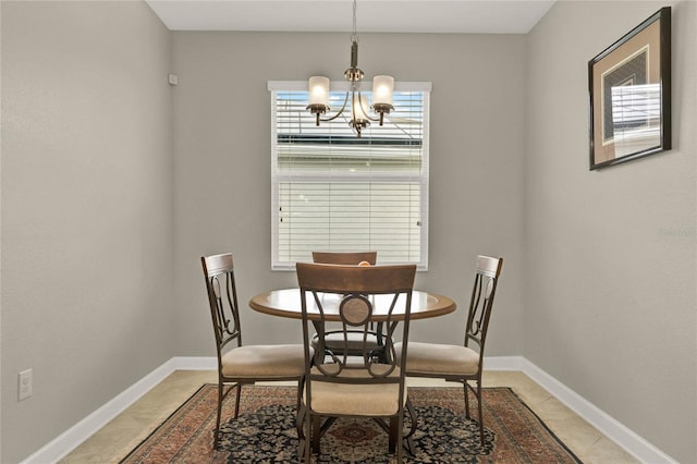 dining room featuring a notable chandelier, light tile patterned flooring, and baseboards