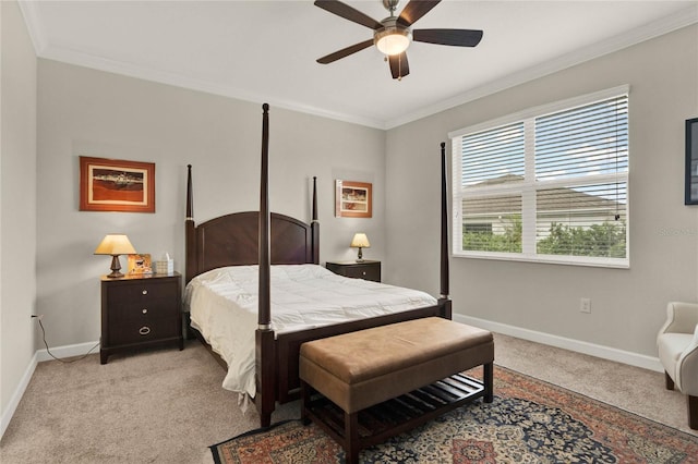 bedroom featuring ornamental molding, light colored carpet, baseboards, and a ceiling fan