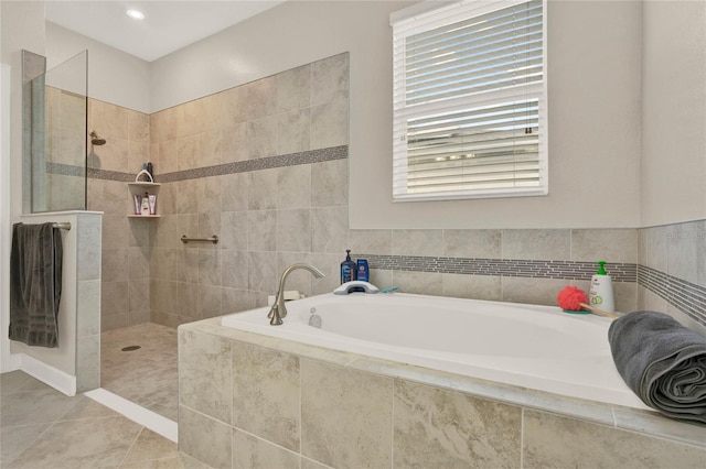 full bath featuring walk in shower, a bath, and tile patterned floors