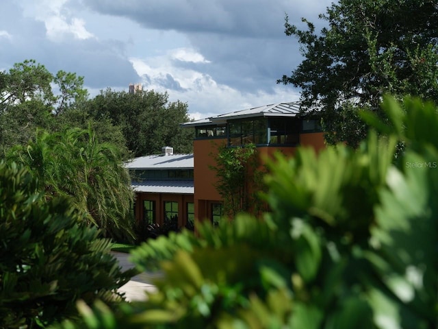 rear view of house featuring a standing seam roof and metal roof