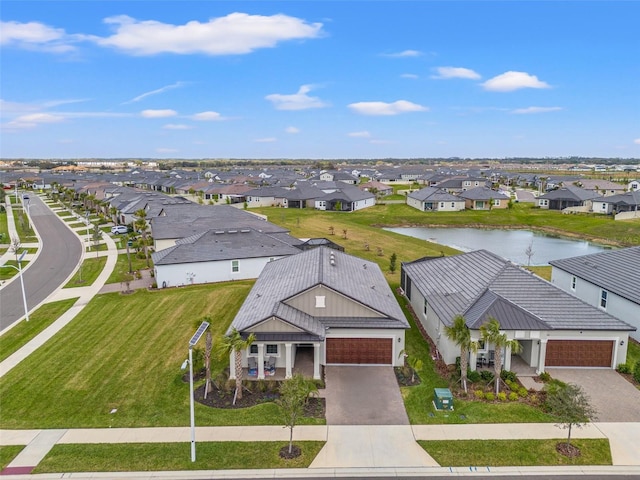 birds eye view of property featuring a residential view and a water view