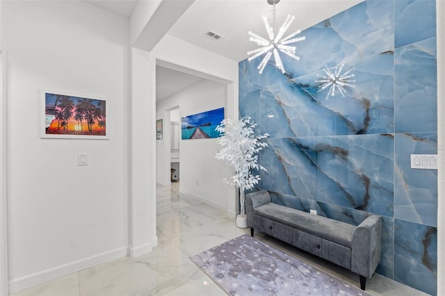 sitting room featuring baseboards, visible vents, arched walkways, marble finish floor, and an inviting chandelier