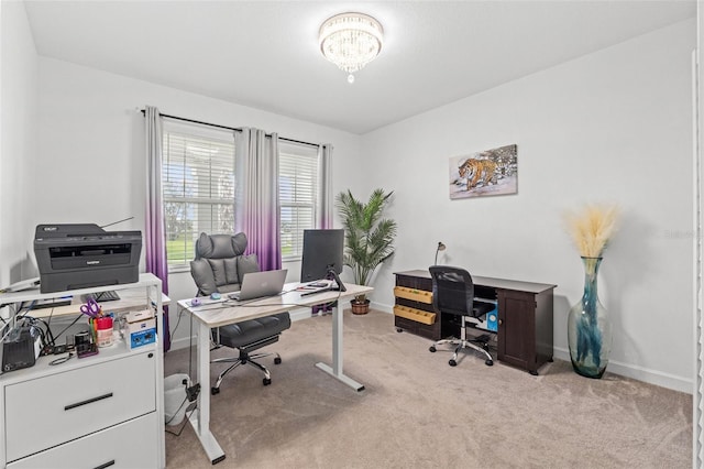 office area featuring light carpet, baseboards, and an inviting chandelier