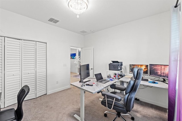 office space with carpet floors, baseboards, and visible vents