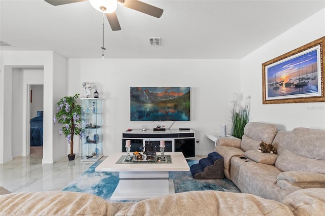 living area featuring marble finish floor, ceiling fan, visible vents, and baseboards