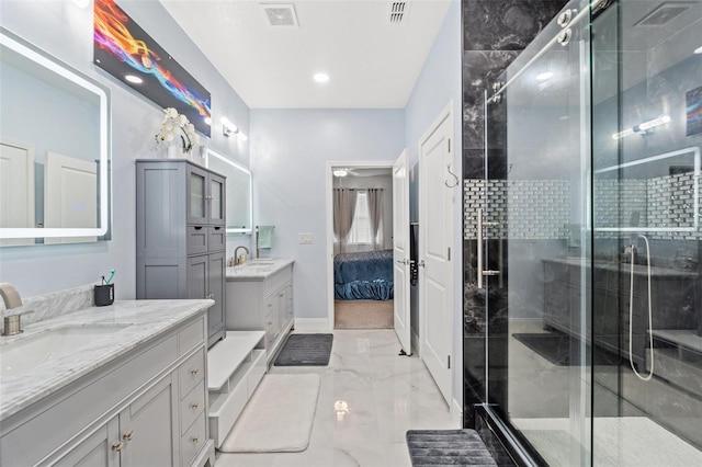 ensuite bathroom featuring marble finish floor, a sink, visible vents, and connected bathroom