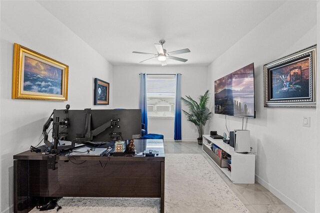 home office with ceiling fan and baseboards