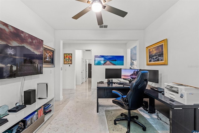 office space featuring a ceiling fan, marble finish floor, visible vents, and baseboards