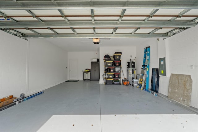 garage featuring a garage door opener, electric panel, and hybrid water heater