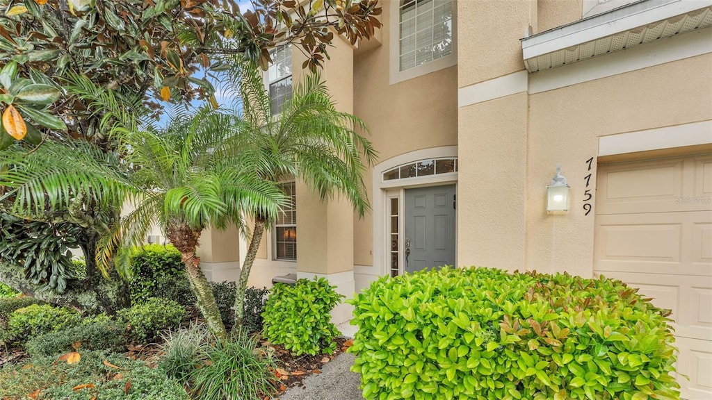 property entrance with stucco siding