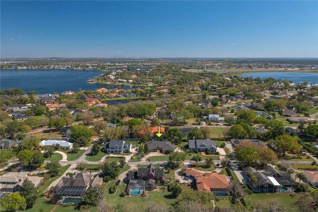 drone / aerial view with a residential view and a water view