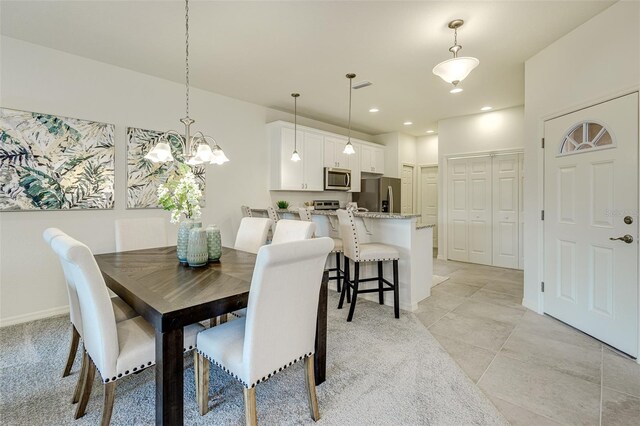 dining space with baseboards, visible vents, and recessed lighting