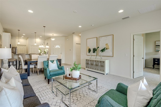 living room featuring light carpet, visible vents, and recessed lighting