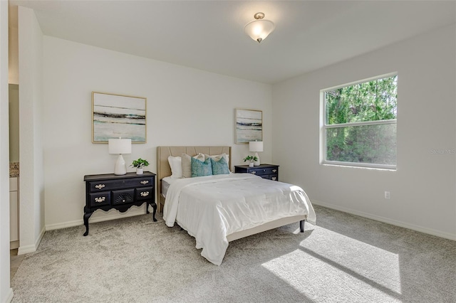 carpeted bedroom featuring baseboards