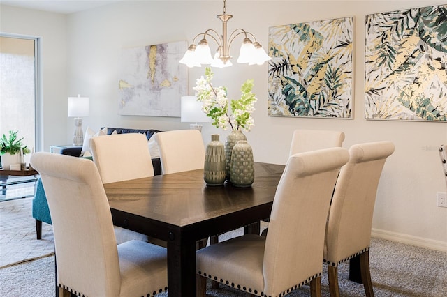 carpeted dining area with baseboards and an inviting chandelier