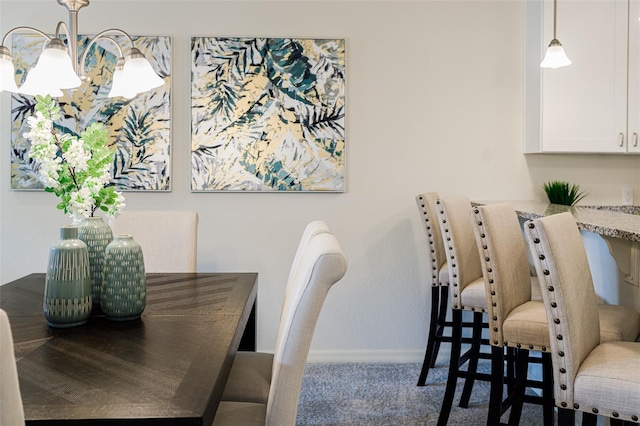 carpeted dining room featuring baseboards