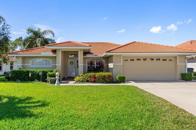 mediterranean / spanish-style home with a front lawn, an attached garage, and stucco siding