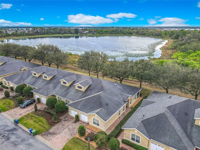 drone / aerial view with a water view and a residential view