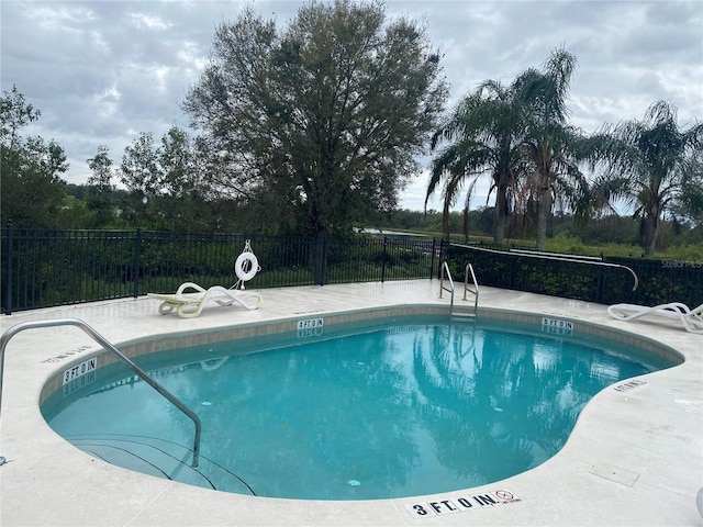 community pool featuring fence