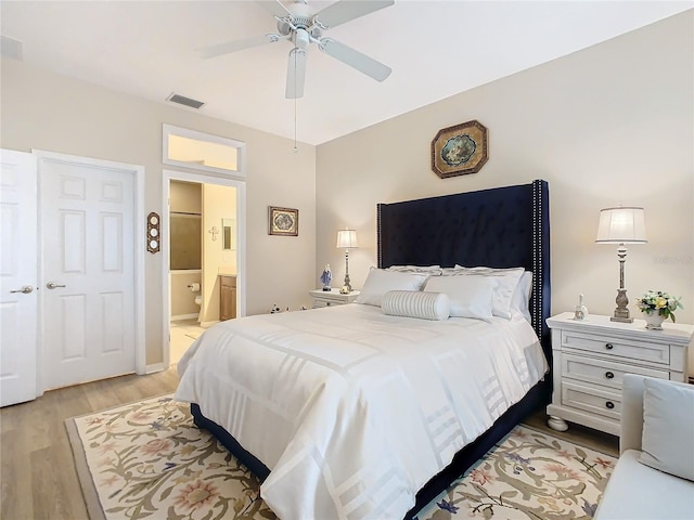 bedroom featuring ensuite bathroom, ceiling fan, light wood-style flooring, and visible vents