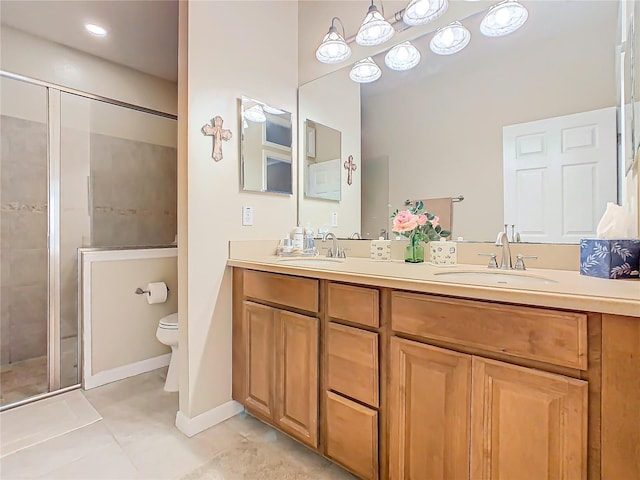 bathroom with double vanity, a stall shower, a sink, and toilet