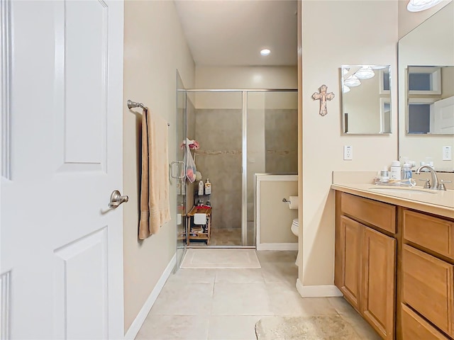 bathroom featuring baseboards, a stall shower, vanity, and tile patterned floors