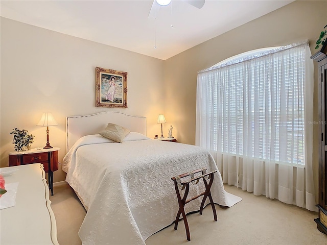 bedroom with light carpet and ceiling fan