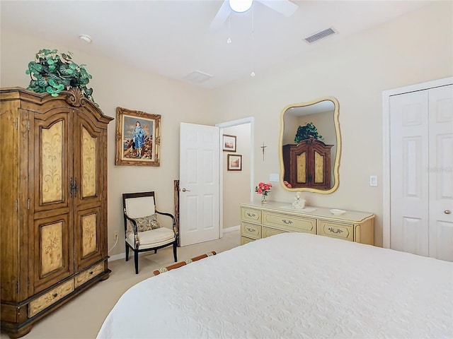 bedroom with a closet, visible vents, a ceiling fan, light carpet, and baseboards