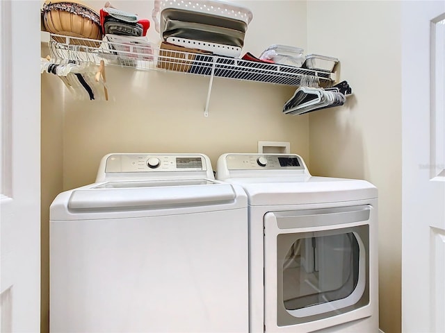 clothes washing area featuring laundry area and washing machine and dryer